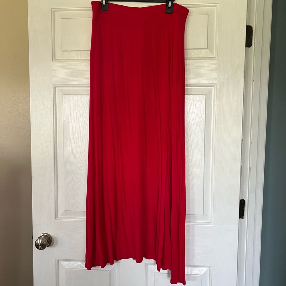 Red maxi skirt with side slit detail.
